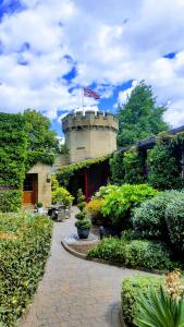 a garden with a building with a flag on top at Garrison Hotel in Sheffield