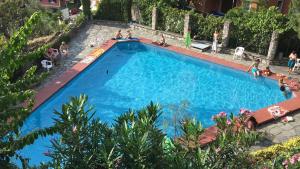 una vista sul tetto di una grande piscina blu con persone all'interno di Agata Apartment Camogli a Camogli