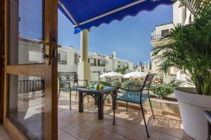 a balcony with chairs and a table on a balcony at Klayman Olivina Aparthotel in Los Cristianos