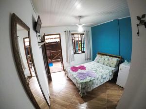 Postel nebo postele na pokoji v ubytování Suítes Cantinho da Pedra