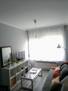 a living room with a couch and a table at Torre Center in Santiago de Compostela