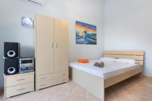 a bedroom with a bed and a speaker at Villa Skala Marion (Michalis) in Skala Marion