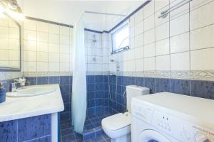 a bathroom with a toilet sink and a washing machine at Villa Skala Marion (Michalis) in Skala Marion +27 photos