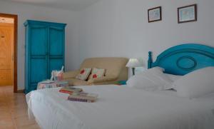 
a bedroom with a white bed and a blue wall at Hotel Al-Andalus in Nerja
