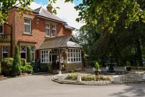 a house with a garden in front of it at Macdonald Kilhey Court Hotel & Spa in Wigan