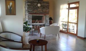 a living room with chairs and a fireplace at Piedra de Agua in Federación