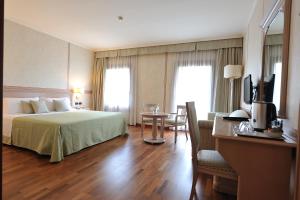 Postel nebo postele na pokoji v ubytování Hotel Roxy Plaza