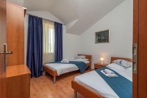Postel nebo postele na pokoji v ubytování Apartments Villa Jelena + 27 fotografií