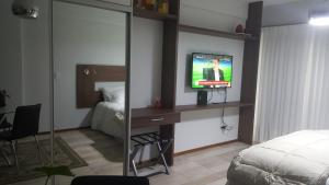 a bedroom with a bed and a television in a room at M&M San Telmo in Buenos Aires