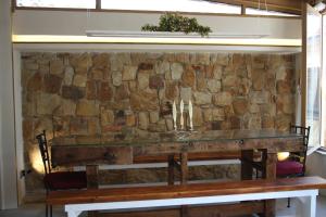 a stone wall with a bench in front of it at Il Borghetto Country Charme in Cefalù +74 photos
