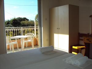 A bed or beds in a room at Galini Studios and Apartments