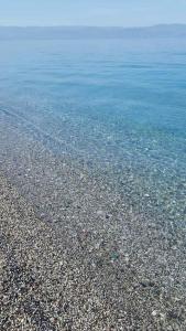 a large body of water with a rocky beach at la casa per le tue vacanze in Milazzo
