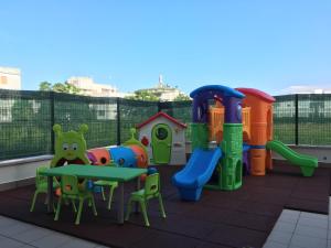 a patio with a playground with a table and chairs at Residence 3 Oblò in Giulianova