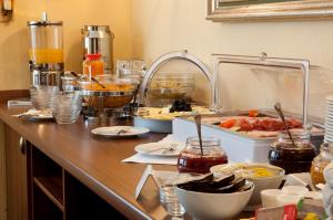 a kitchen counter filled with lots of food at City Hotel garni in Idar-Oberstein