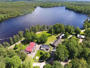 an aerial view of a farm with a lake at Den Sovande Älgen in Markaryd