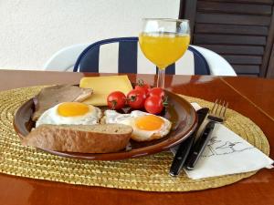 einen Teller Eier und Brot und ein Glas Orangensaft in der Unterkunft Art Apartment in Skradin