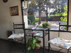 un patio con 2 sillas, una mesa y una mesa con sillas en Green Hotel en Pilar