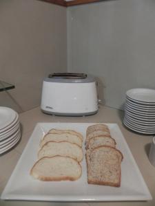 a white plate with slices of bread on a counter at Mirando al Sur in San Carlos de Bariloche