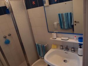 a bathroom with a toilet and a sink and a shower at Casa Gialla in Costa Paradiso +8 photos