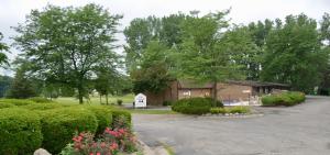 a house with a parking lot in front of it at Arbor Inn of Historic Marshall in Marshall