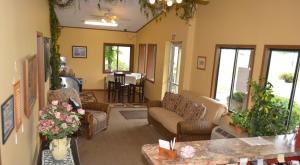 a living room with a couch and chairs and a table at Arbor Inn of Historic Marshall in Marshall