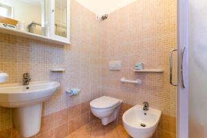 a bathroom with a toilet and a sink at Hotel Rubens in Rimini