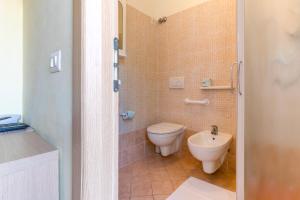 a bathroom with a toilet and a sink at Hotel Rubens in Rimini
