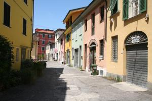 an empty alley with colorful buildings in a city at The Old Laundry in Lucca