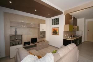 a living room with a couch and a tv at The Old Laundry in Lucca