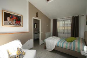 a small bedroom with a bed and a window at The Old Laundry in Lucca