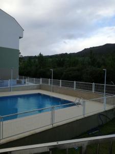 a swimming pool on top of a building at Apartamento Costa de Lugo in Foro
