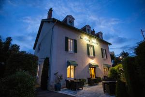 a white building with a sign on the side of it at Hotel La Villa Fleurie in Beaune