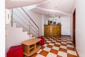 a living room with a table and a checkered floor at Vila Blue Eforie Nord in Eforie Nord