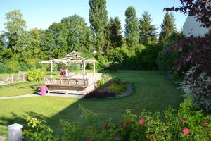 a garden with a wooden gazebo in the grass at Bubble Dreams in Coupéville