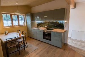 a kitchen with a table and a stove top oven at Weinhof Klug-Krainer in Deutschlandsberg