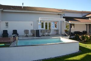 a backyard with a swimming pool and a house at Bubble Dreams in Coupéville