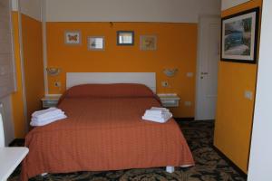Postel nebo postele na pokoji v ubytování Hotel Poggio d'Oro