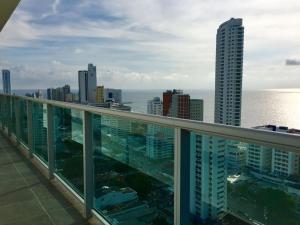 a view of the ocean from the balcony of a building at luxuriuso apartament in Cartagena de Indias +39 photos