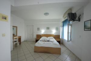 A bed or beds in a room at Irini Plomariou Apartments