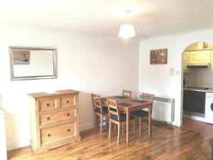 a kitchen and dining room with a table and chairs at Saint Paul's in Dublin