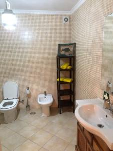 a bathroom with a toilet and a sink at Casa da Porta Nova in Tavira