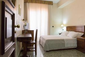 a hotel room with a bed and a television at Hotel Arcobaleno in Taureana