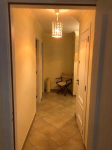 an empty hallway with a table and a chandelier at Casa da Porta Nova in Tavira