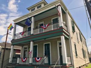 a house with american flags on the balcony of it at Site 61 Hostel in New Orleans
