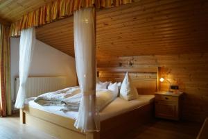 a bedroom with a bed with a canopy at Schusterhof in Innsbruck