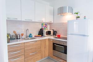 a kitchen with wooden cabinets and a white refrigerator at 552 AVENUE DE VALESCURE in Saint-Raphaël