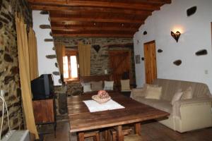 a living room with a table and a couch at Aldeia Oliveiras in Sobreira Formosa