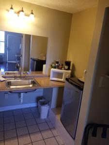
a bathroom with a sink and a counter top at Gulfcoast Inn Naples in Naples
