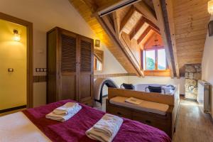 a bedroom with a bed with purple sheets and a window at Balcon del Pirineo Rural Ordesa in Buesa