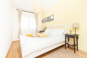 a white bedroom with a white bed and a window at Harmony Trsat in Rijeka